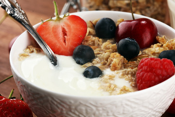 Cereal. Bowl of granola cereals, fruits and milk for breakfast. Muesli with cereals.