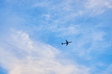 the plane taking off from the airport in the afternoon, against the background of clouds.