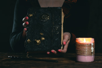 Book of magic in a magician hands. Witchcraft.