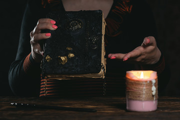 Book of magic in a magician hands. Witchcraft.