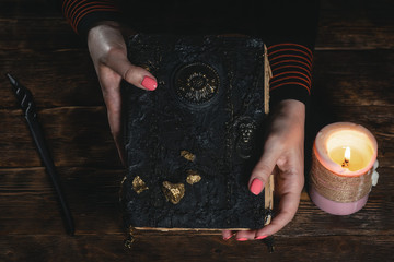 Book of magic in a magician hands. Witchcraft.