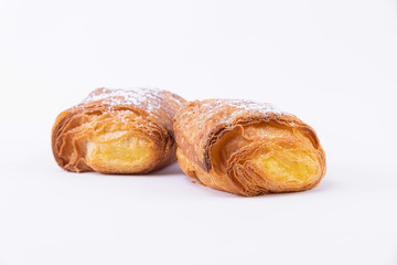Two puff pastry rolls with powdered sugar
