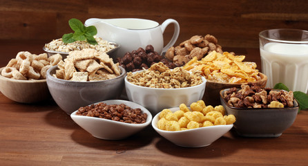 Cereal. Bowls of various cereals and milk for breakfast. Muesli with kids cereals.