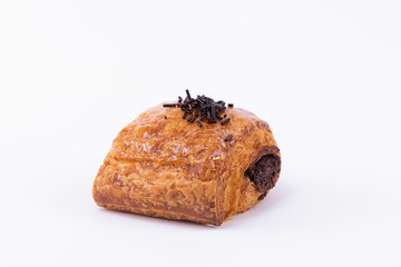 Side view of a puff pastry roll filled with chocolate