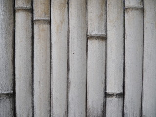 White bamboo wall front view. Bamboo background. Closeup white bamboo wall.