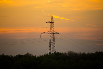 Fototapeta na wymiar high voltage towers against sunrise