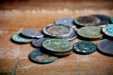 Pile of different ancient copper coins with patina.