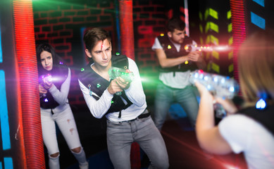 Excited guy laser tag player in bright beams