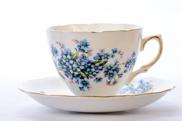 Tea Cup with Blue Floral Design against White BG with Copy Space