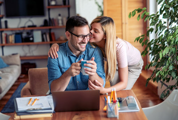 Cuple using laptop at home