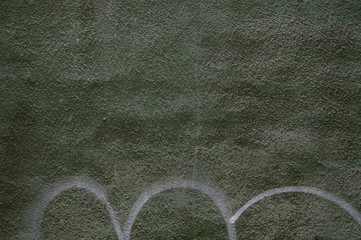 Textured wall, green-marsh color, with white paint painted on it, rounded stripes.
