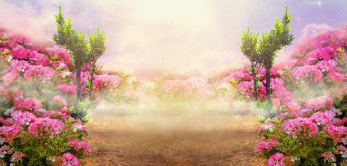 Fantasy summer panoramic photo background with rose field, trees and misty path leading to...