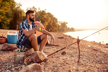 Young man fishing on a river