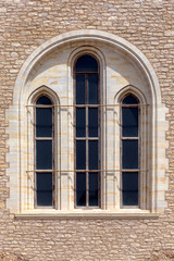 The background old beige stony wall with marble window