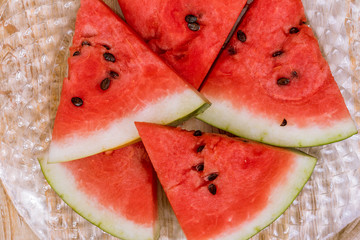 Pieces of watermelon on a wooden background