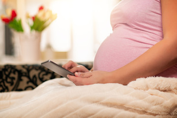 Obraz na płótnie Canvas Pregnant woman using tablet
