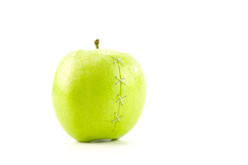 green apple with stapled crack