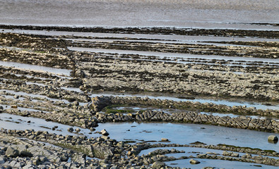 East Quantoxhead beach in Somerset. The limestone pavements date to the Jurassic era and are a...