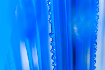 Obraz na płótnie Canvas blue tulle and beads with a chain link