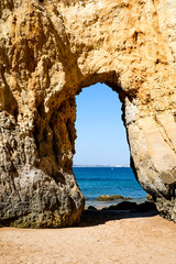 big arch on the beach in Lagos Portugal, passageway into the water