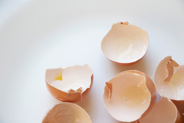 Delicate Egg Shells on a White and Airy Background. Baking or cooking background. Walking on eggshells background. Broken and shattered background.