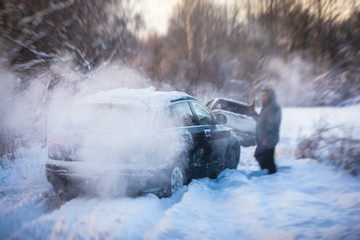 Process of taking out suv car stuck in snow, men digging and pushing the car out of snow, concept of winter problems with car