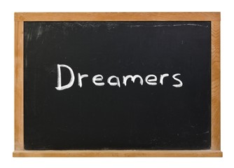 Fototapeta premium Dreamers written in white chalk on a black chalkboard isolated on white