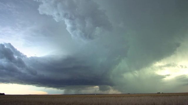 Time lapse of severe storm moving through the plains in tornado alley as lightning flashes in the sky.