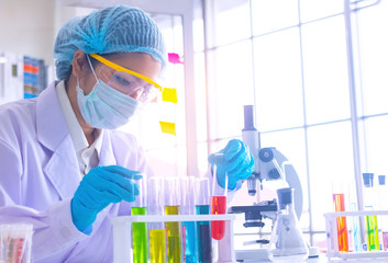 Body past scientist working in laboratory.She is trying and research with red and blue test tube. Experiment , chemical Photo concept develop and medicine.