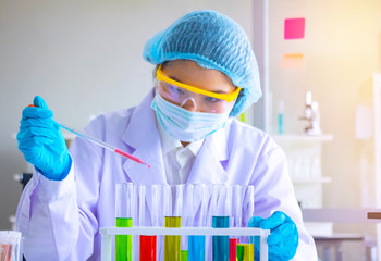 Body past scientist working in laboratory.She is trying and research with red and blue test tube. Experiment , chemical Photo concept develop and medicine.