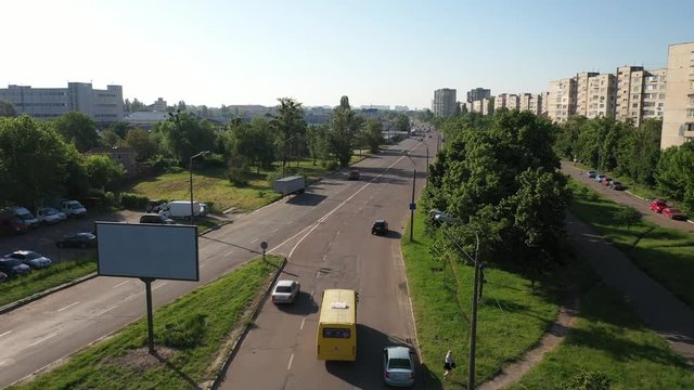Aerial view of the traffic in Kyiv, Ukraine, next to an electrical with a Housing Complex on the right. Drone flying slowly forward