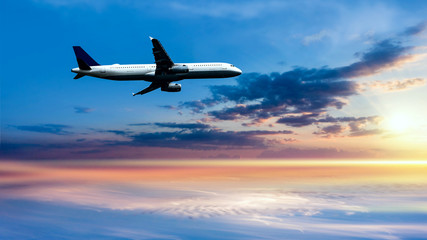 Fototapeta na wymiar Airplane in the sky at sunrise . Plane Background Blue Sky White Clouds