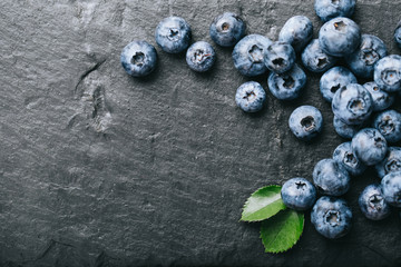 Fresh blueberry on stones background. Texture blueberry berries close up. Vegan and vegetarian concept.