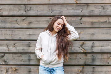 Happy girl smiling. Beauty portrait young happy positive laughing brunette woman on wooden wall...