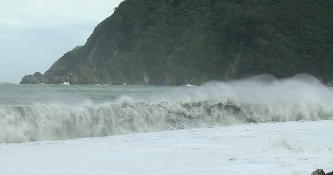 Large Waves Crash Onto Rugged Mountainous Coastline - Megi