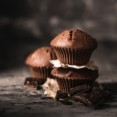 Sweet muffins with on dark textured background.