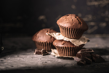 Sweet muffins with on dark textured background.