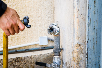 Operator connecting a hose to a tap.
