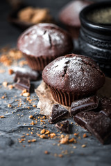 Muffin with coffee on dark textured background.