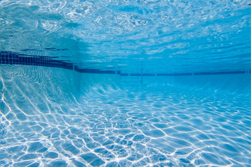Underwater in clean, empty suburban swimming pool.