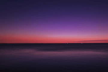 Blue sea, pink orange sky at sunset. Summer sea scenic landscape on sunny evening