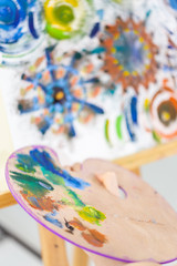 Artist painting art, selective focus close-up on palette
