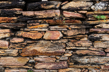 texture of old stone wall, wall made in the 17th century, in Ouro Preto, Brazil.