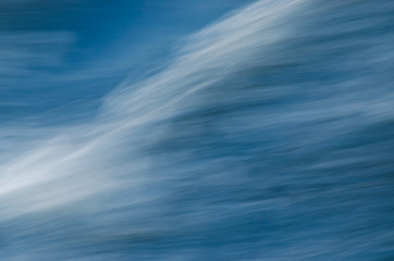 Sea wave from the side of the ship close-up on a long exposure. Water texture