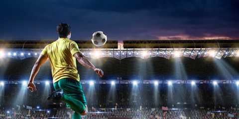 Soccer player on stadium in action. Mixed media