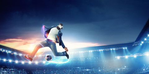 Obraz na płótnie Canvas Virtual Reality headset on a black male playing soccer. Mixed media