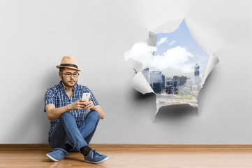 Young man sitting on the floor, a moment for relax concept. Mixed media