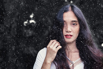 The face of a rustic charming young woman She has a freckle on the face, white skin, red lips, dark green eyes.