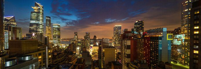 Panoramic view of Manhattan skyscrapers lights, New York city, in the evening