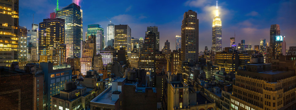 Fototapeta Panoramic view of Manhattan skyscrapers lights, New York city, in the evening
